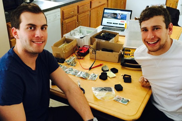 Charles Fayal '16 (ENG), left, and Steven Graf '15 (BUS) take a break from assembling their Parrot MD devices.