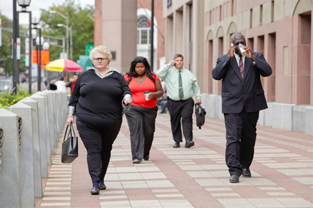 Overweight people walking down a city street. (Photo courtesy of the Rudd Center)