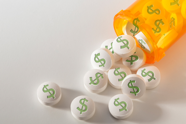 Prescription medication spilling from an open bottle onto a white textured table top.