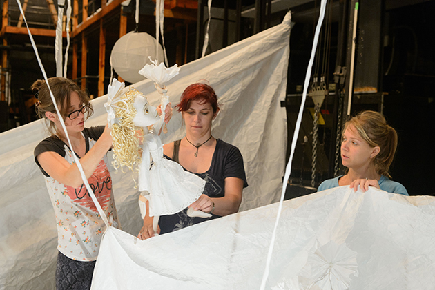 Sarah Nolen '15 MFA, left, Ceili Clemens '01 (SFA), and Lucia Rich, a professional performer, operate the puppet 'Aya' during a rehearsal for 'Unfolding the Story: A Journey of Her Own' at the Studio Theater on Sept. 11, 2015. (Peter Morenus/UConn Photo)