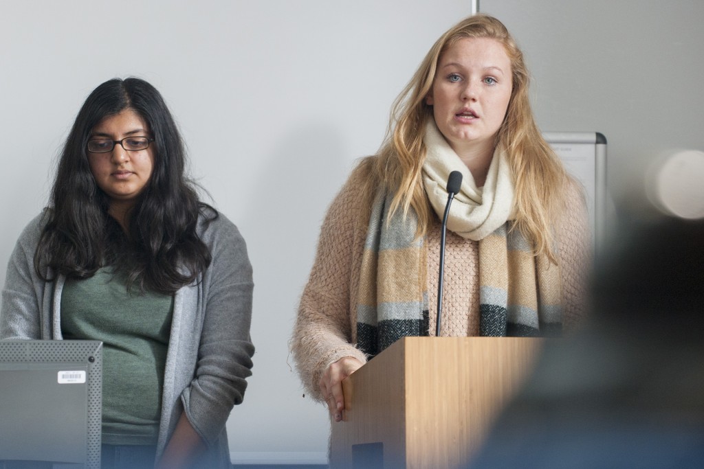 Anna Middendorf, right, gives a presentation during a human rights class taught by Professor Shareen Hertel in Oak Hall. (Sean Flynn/UConn Photo)