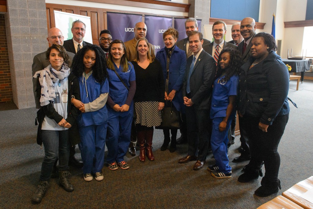 Legislators, UConn and Hartford schools administrators and high school students pose for a photograph following the Hartford Promise announcement held at Mark Twain branch of the Hartford Public Library at Hartford Public High School on Jan. 12, 2016. (Peter Morenus/UConn Photo)