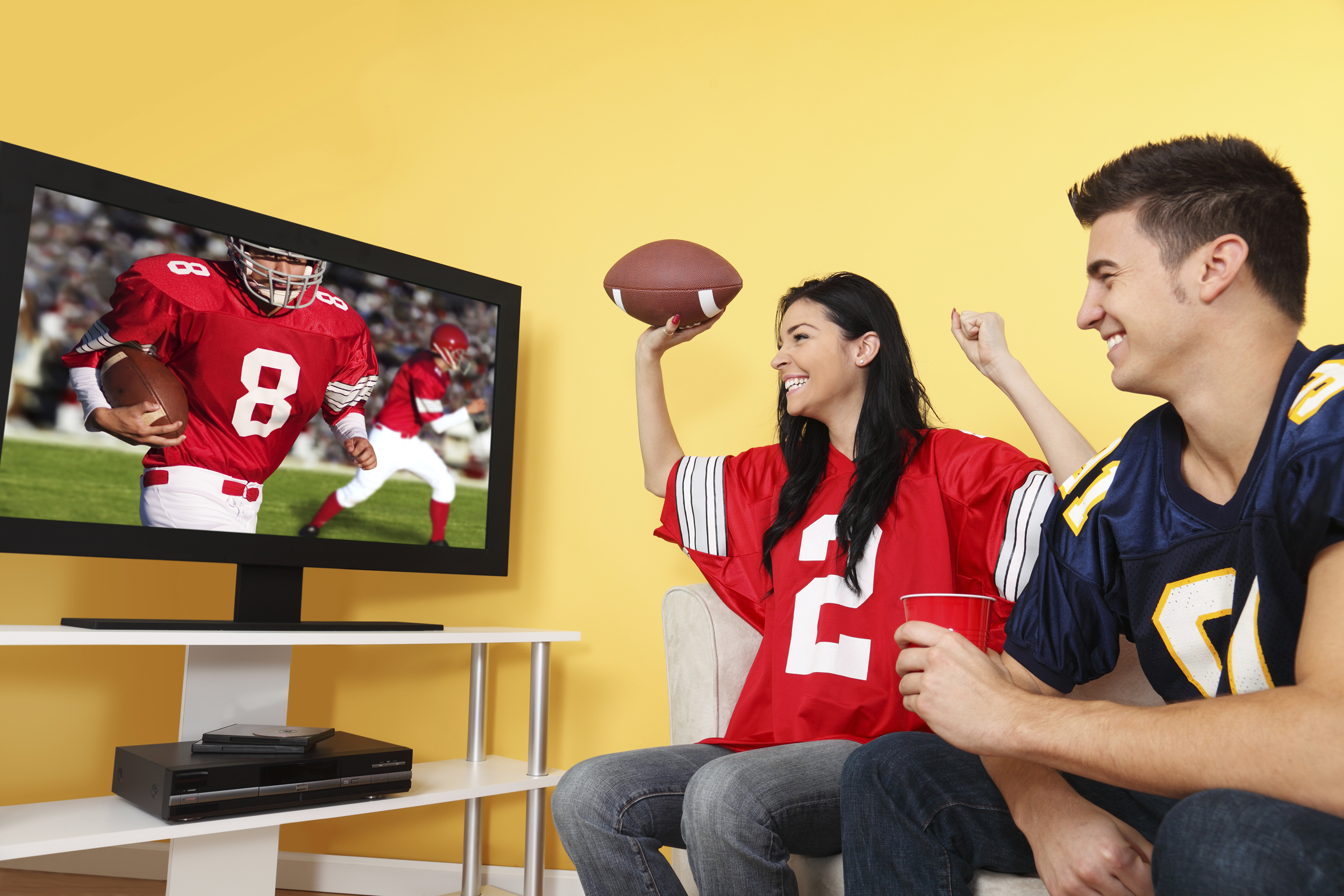 Fans watching a football game on TV. (iStock Photo)