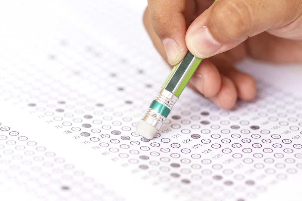 Close-up of hand with a pencil on an answer sheet. (iStock Photo)