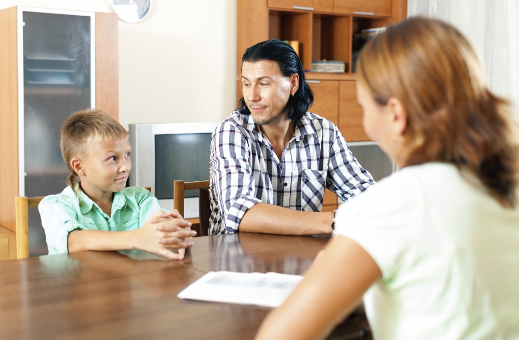 Father and son being interviewed by a professional. (iStock image)