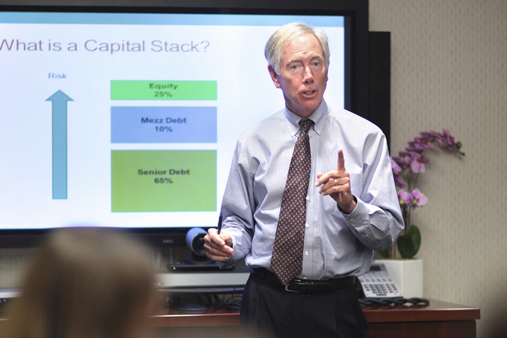 David J. Reilly, former and now retired CEO of Cornerstone Real Estate Advisers, addresses students in the course, "Real Estate: The Practical Approach." (UConn photo)