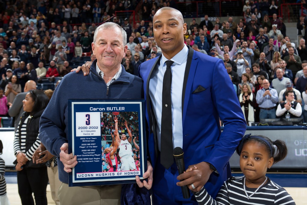 Former Husky Caron Butler celebrates his induction into Huskies of Honor along with his former coach, Jim Calhoun, and his daughter. (UConn Athletic Communications Photo)