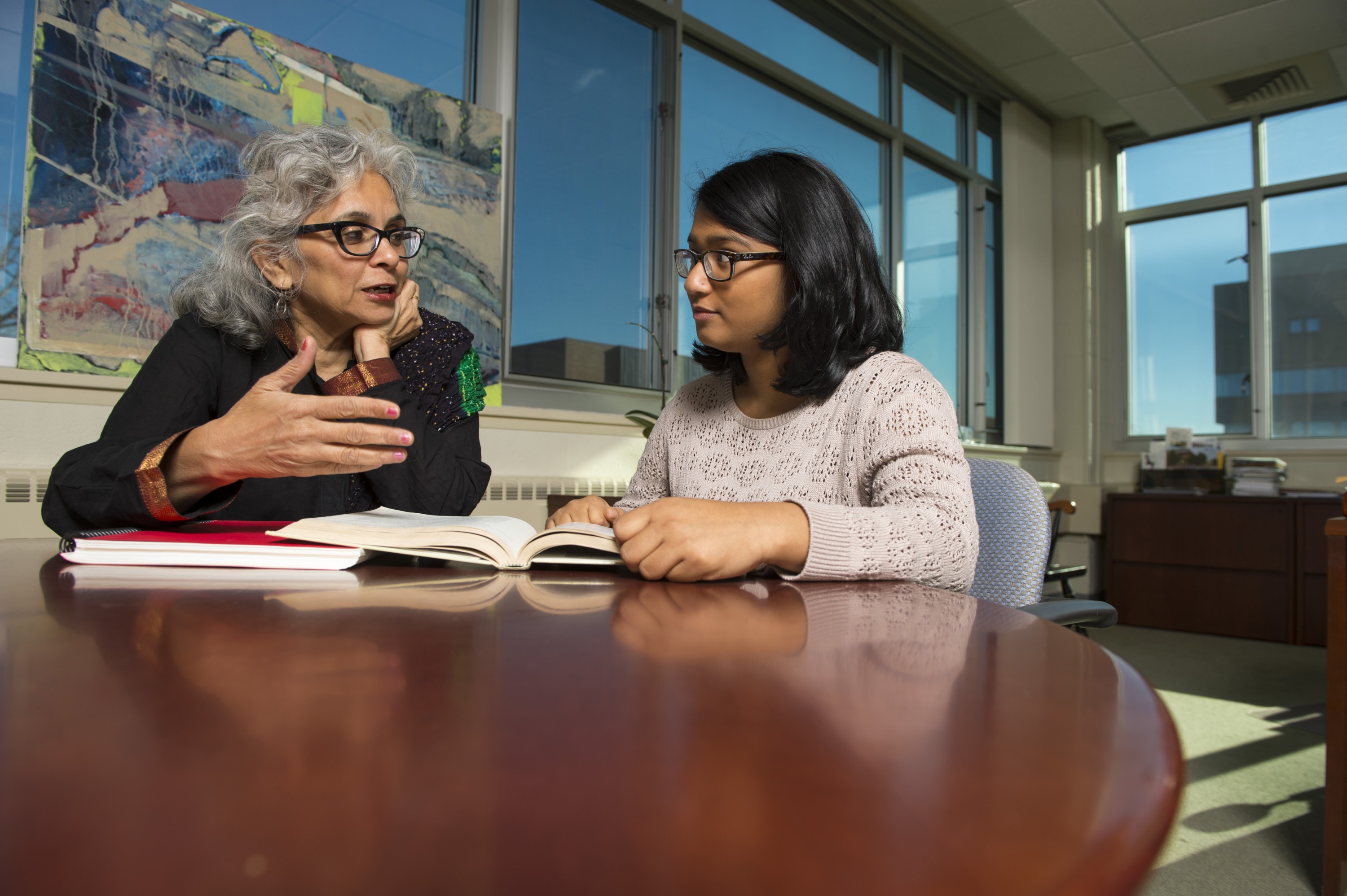 Manisha Desai, associate professor of women's studies and sociology, meets with Asahi Hoque '16 (CLAS) on Nov. 19, 2013. (Peter Morenus/UConn Photo)