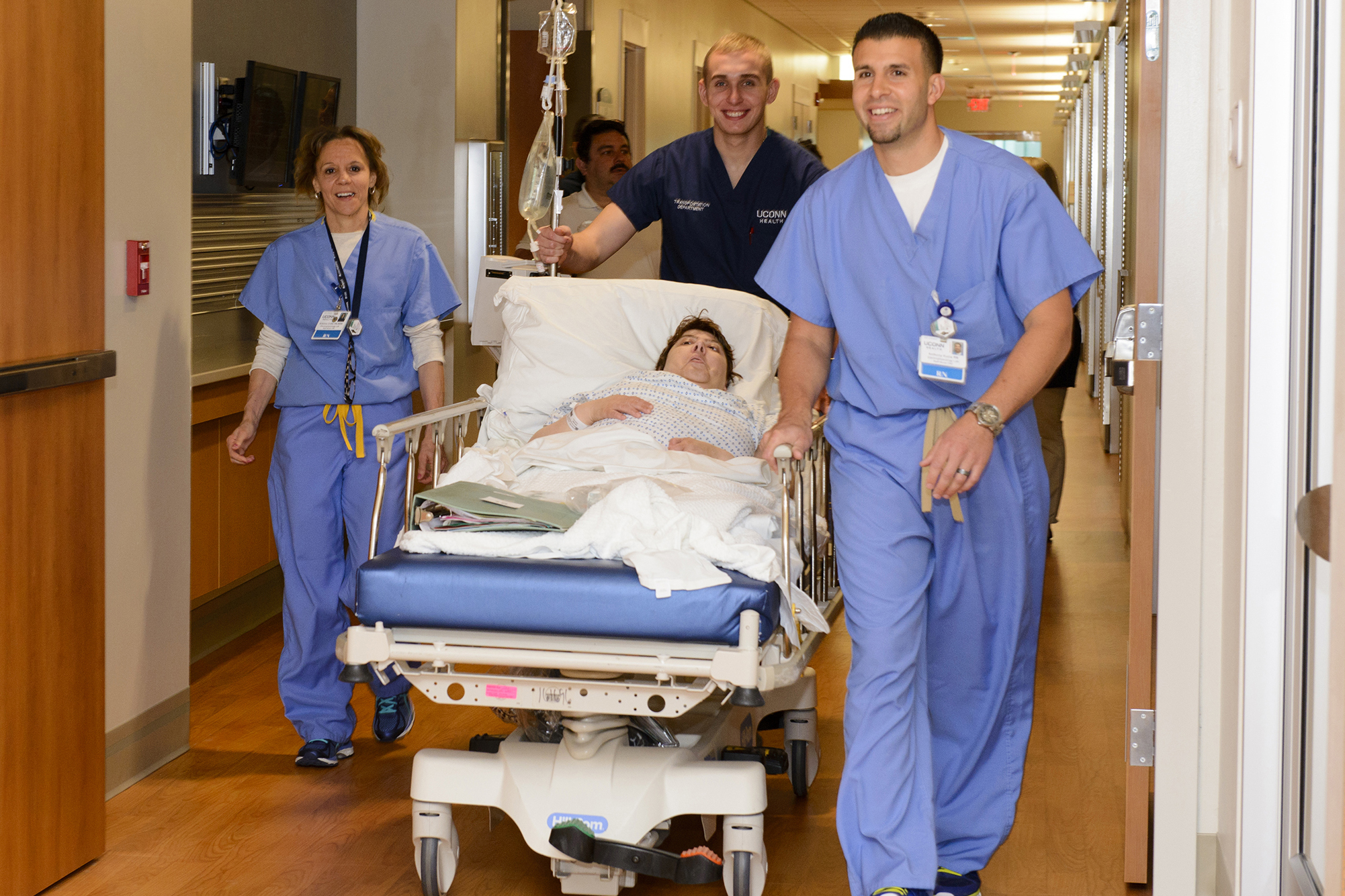 UConn Health nursing staff wheel a patient into the new hospital tower. (Janine Gelineau/UConn Health Photo)