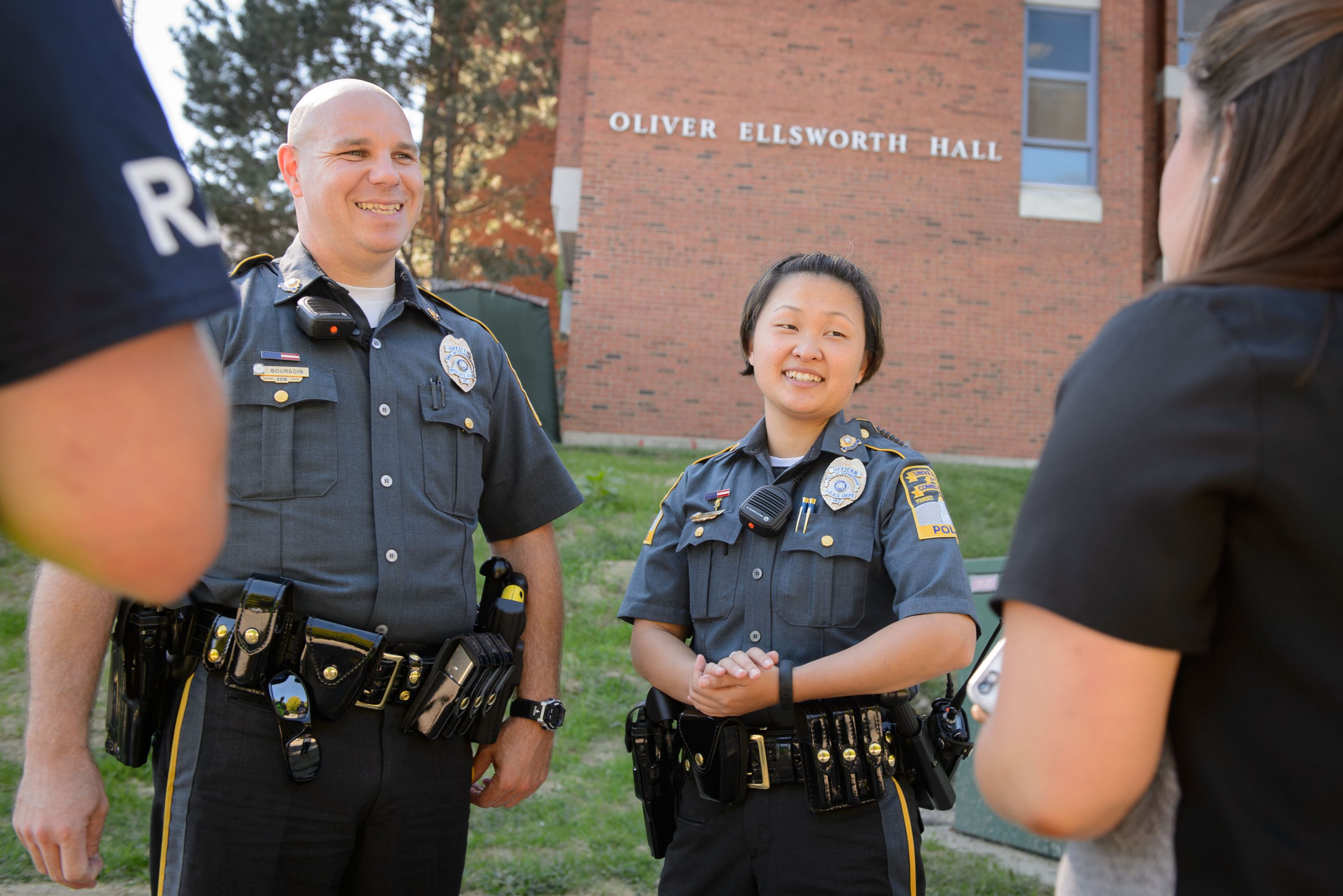 New UConn Police Officers Gary Bourgoin Susannah Hildebidle speak with students outside Oliver Ellsworth Hall on Aug. 28, 2015. (Peter Morenus/UConn Photo)