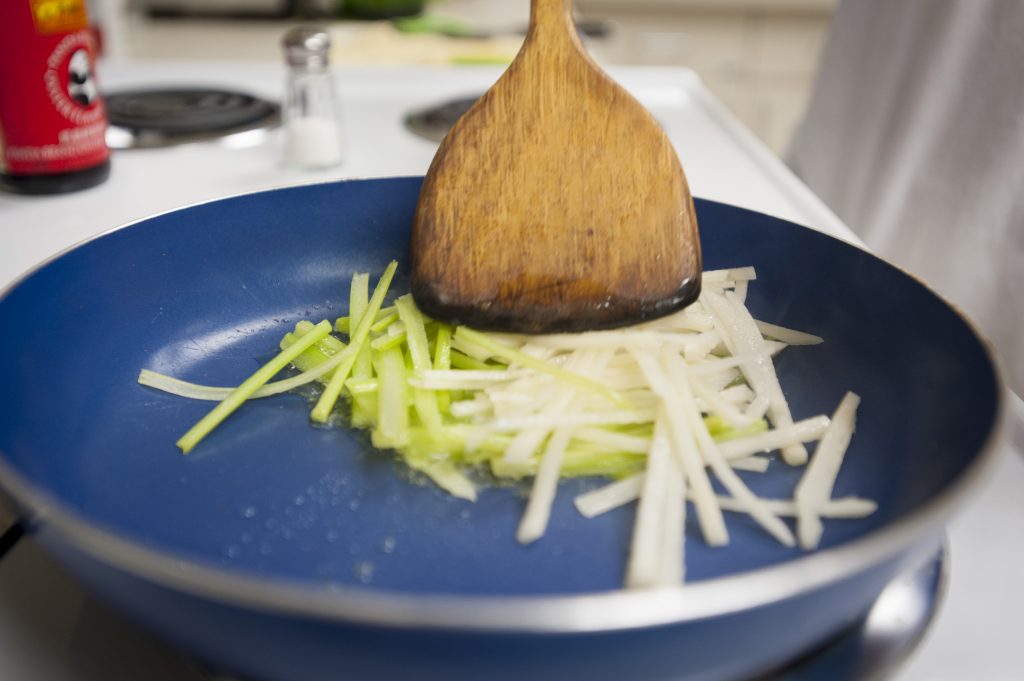 IDEA grant student Jia ‘James’ Lun cooking Asian-style potatoes on June 20, 2016. (Sean Flynn/UConn Photo)