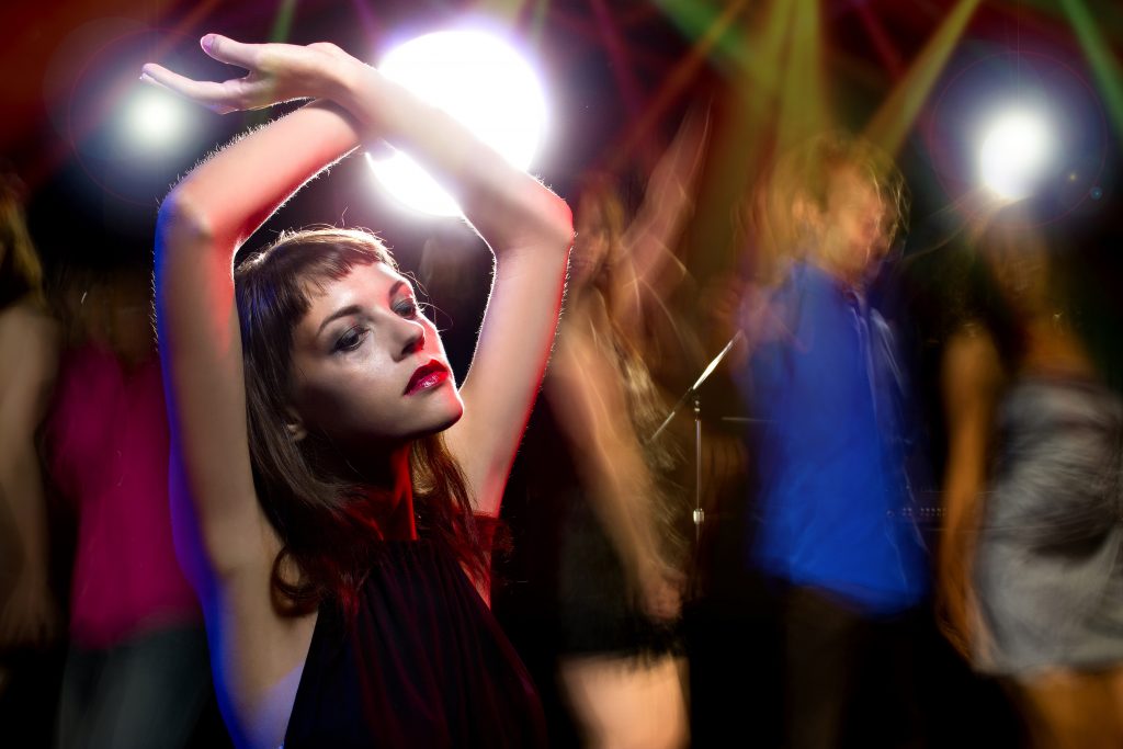 Photo of an intoxicated female dancing at a nightclub and high on drugs or drunk on alcohol. Her make up is smeared like a junkie. She is either a drug addict or an alcoholic. (iStock Photo)