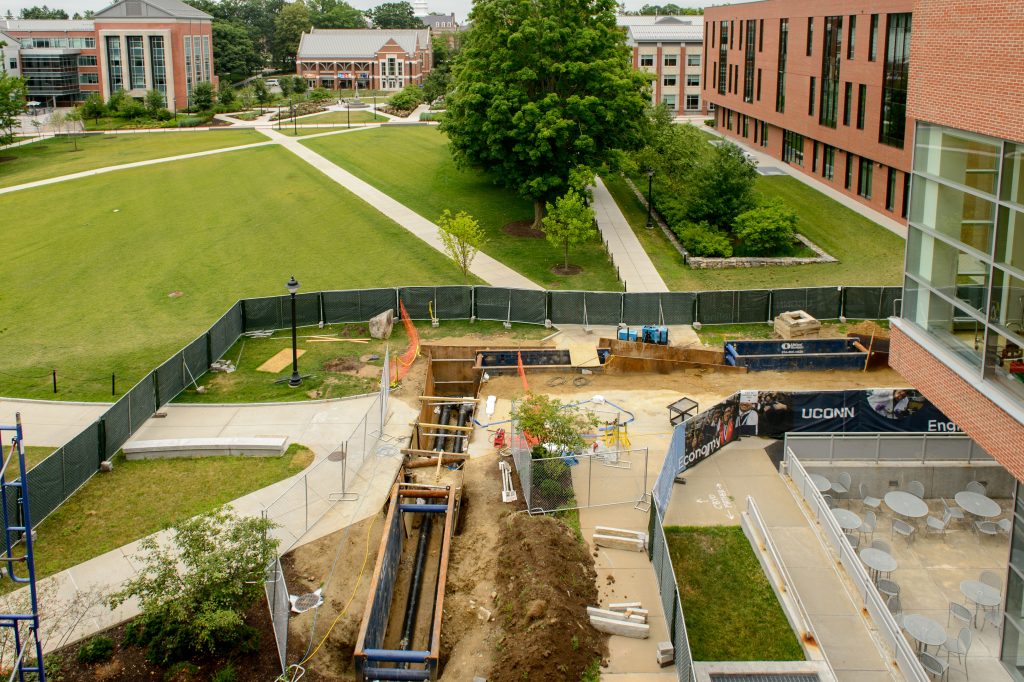 Workers replace steam pipes outside the Student Union on July 8, 2016. (Peter Morenus/UConn Photo)