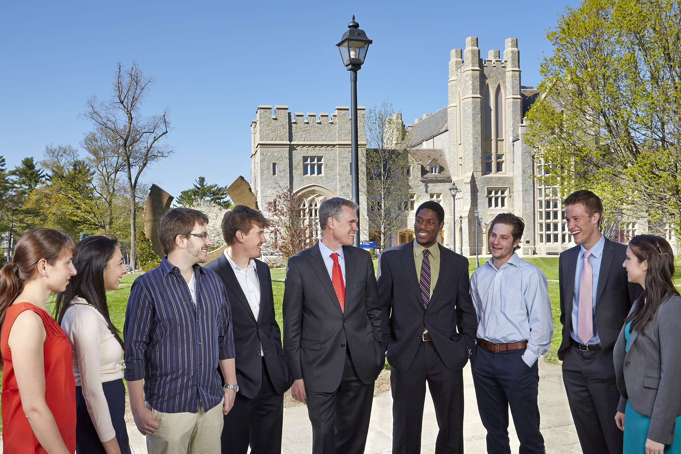 Law School Dean Timothy S. Fisher, center, and students on the campus of UConn Law. (Lanny Nagler Photography for UConn)