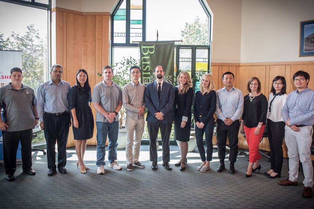 New faculty members pose for a photograph during orientation. Fourteen new faculty members join the UConn School of Business for the Fall 2016 semester. (Nathan Oldham/UConn photo)