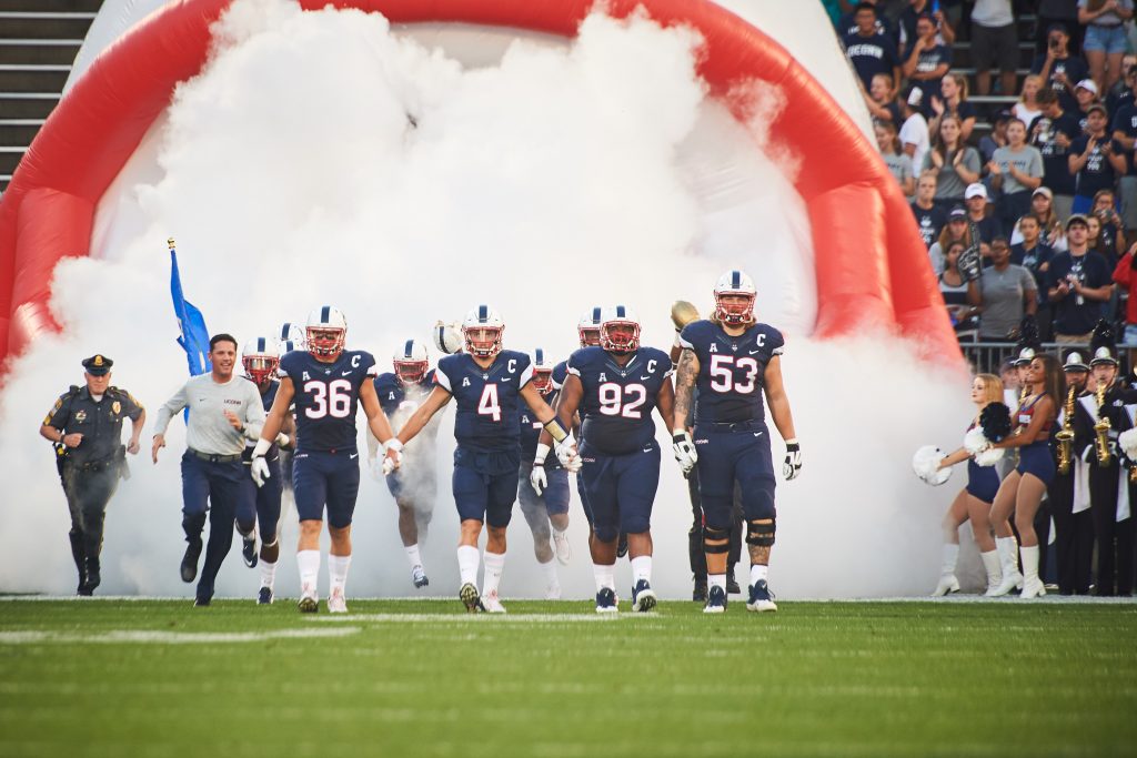 The football team enters Pratt & Whitney Stadium at Rentschler Field on Sept. 1, 2016. (Peter Morenus/UConn Photo)