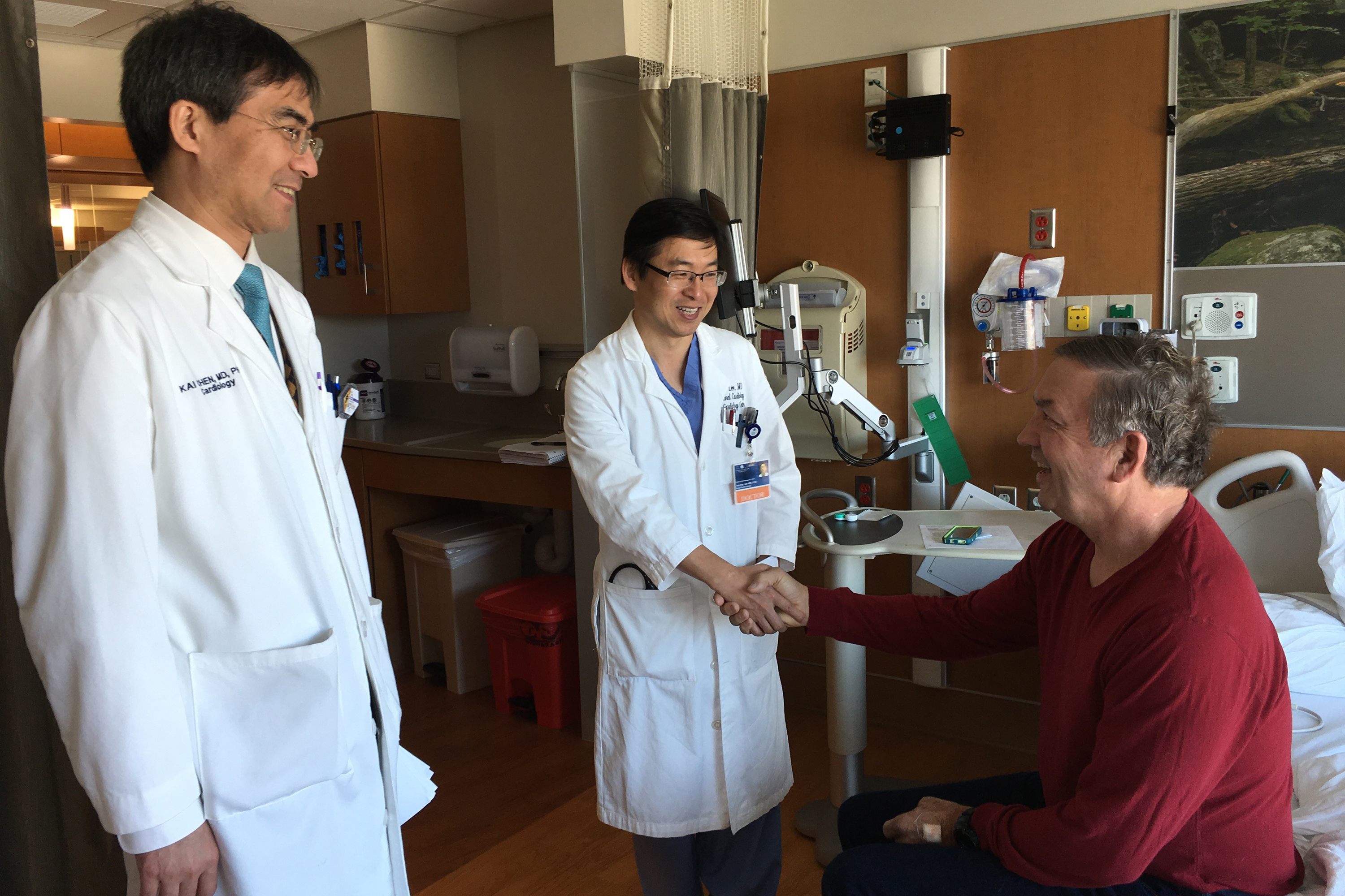 Thanks to prompt treatment by UConn Health team Drs. Kai Chen, left, and Juyong Lee, patient Clyde Livingston gets 'a second chance at life.' (Lauren Woods/UConn Health Photo)