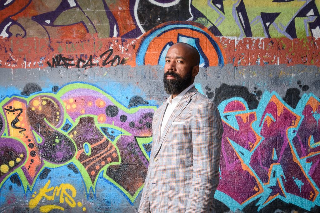 Jeffrey Ogbar, professor of history, stands near graffiti art at the Heaven Skatepark in Hartford on July 12, 2016. (Peter Morenus/UConn Photo)