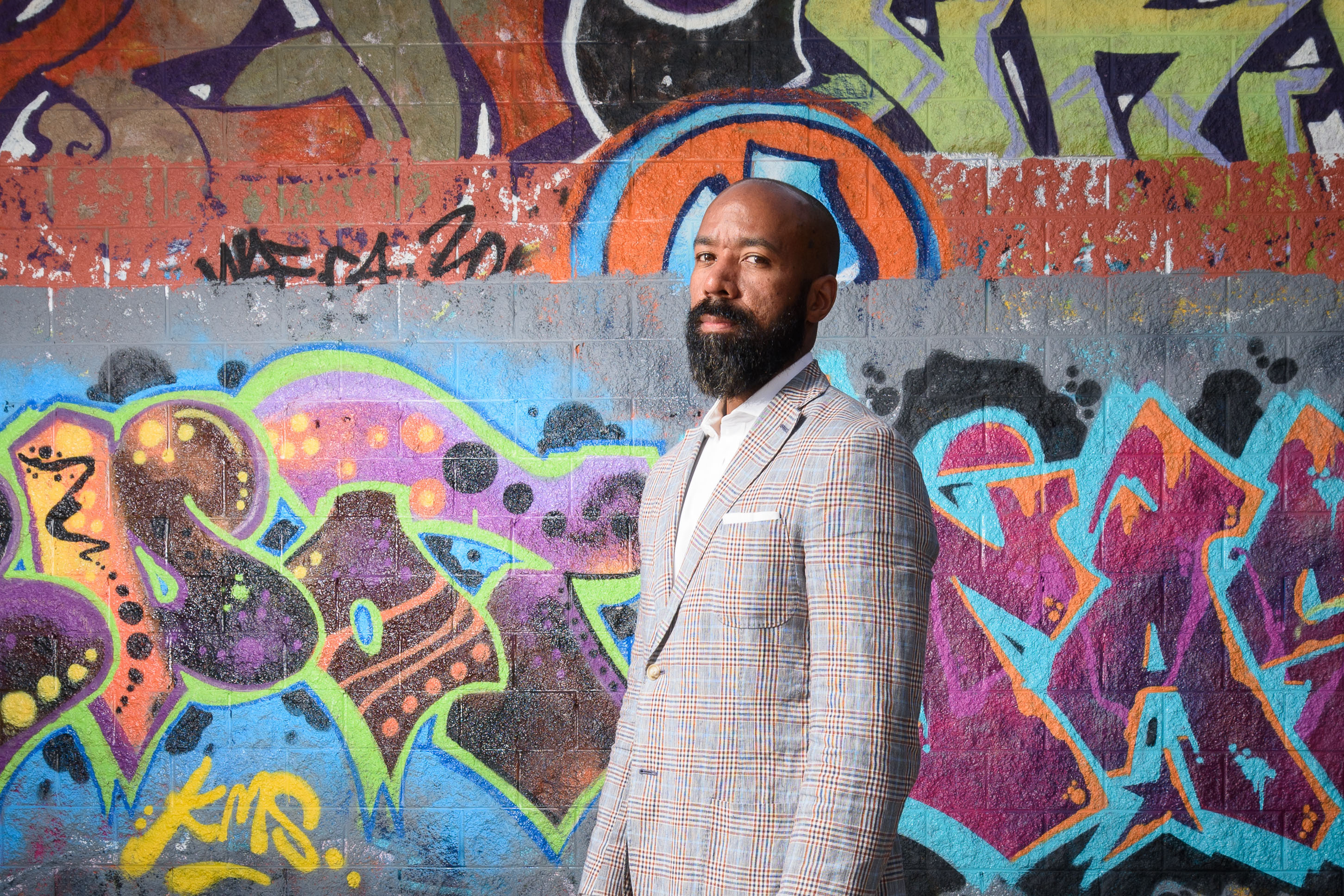 Jeffrey Ogbar, professor of history, stands near graffiti art at the Heaven Skatepark in Hartford on July 12, 2016. (Peter Morenus/UConn Photo)