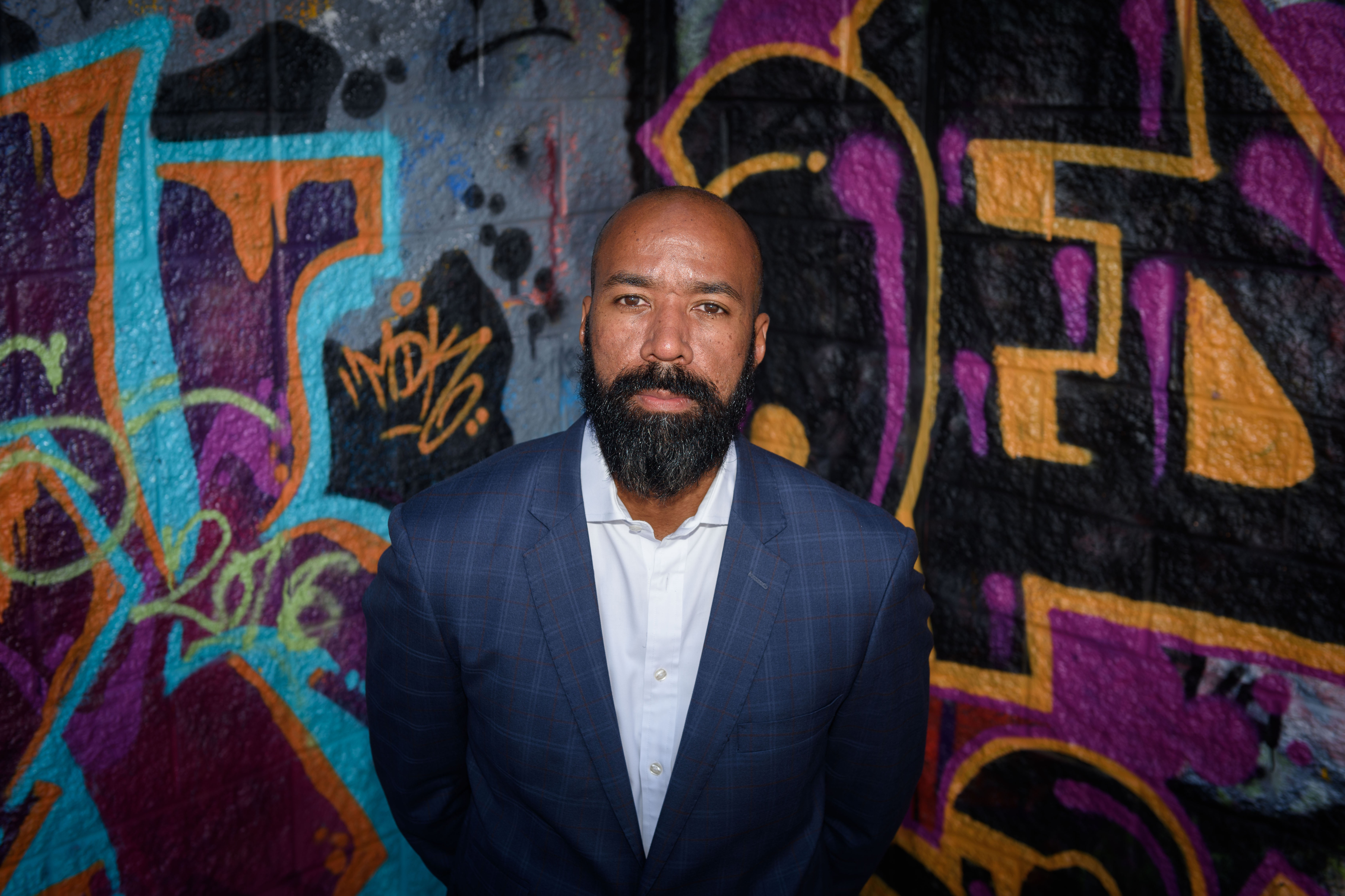 Jeffrey Ogbar, professor of history, stands near graffiti art at the Heaven Skatepark in Hartford on July 12, 2016. (Peter Morenus/UConn Photo)