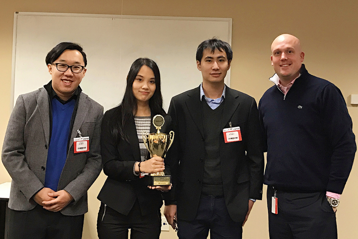 Photo, left to right: MSBAPM students Zhong He '17, Xin "Amy" Ni '16, and Jun Sun '16 pose for a photo with Patrick Buckley, manager of the Advanced Analytics Leadership Development Program at Travelers, following the UConn team’s victory. (Xin "Amy'' Ni)