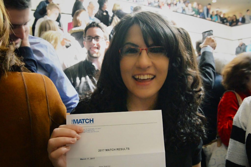 Neda Shahriari displays the letter informing her that she will do her dermatology training at her first-choice placement – UConn Health. (Bret Eckhardt/UConn Photo)