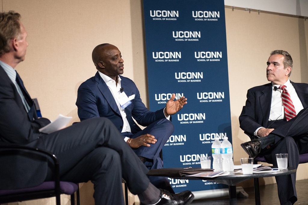 From left: Mark Fagan, office managing partner at Citrin Cooperman, Oni Chukwu, CEO and member of the board of directors at etouches, and John J. Preli, director of regulatory management and governance for The Weather Co. (Nathan Oldham/UConn photo)