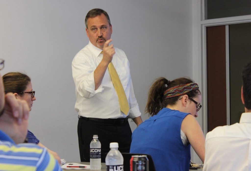 Charles F. Caley, Clinical Professor of Pharmacy Practice, speaking to seminar attendees. (Sheila Foran/UConn Photo)