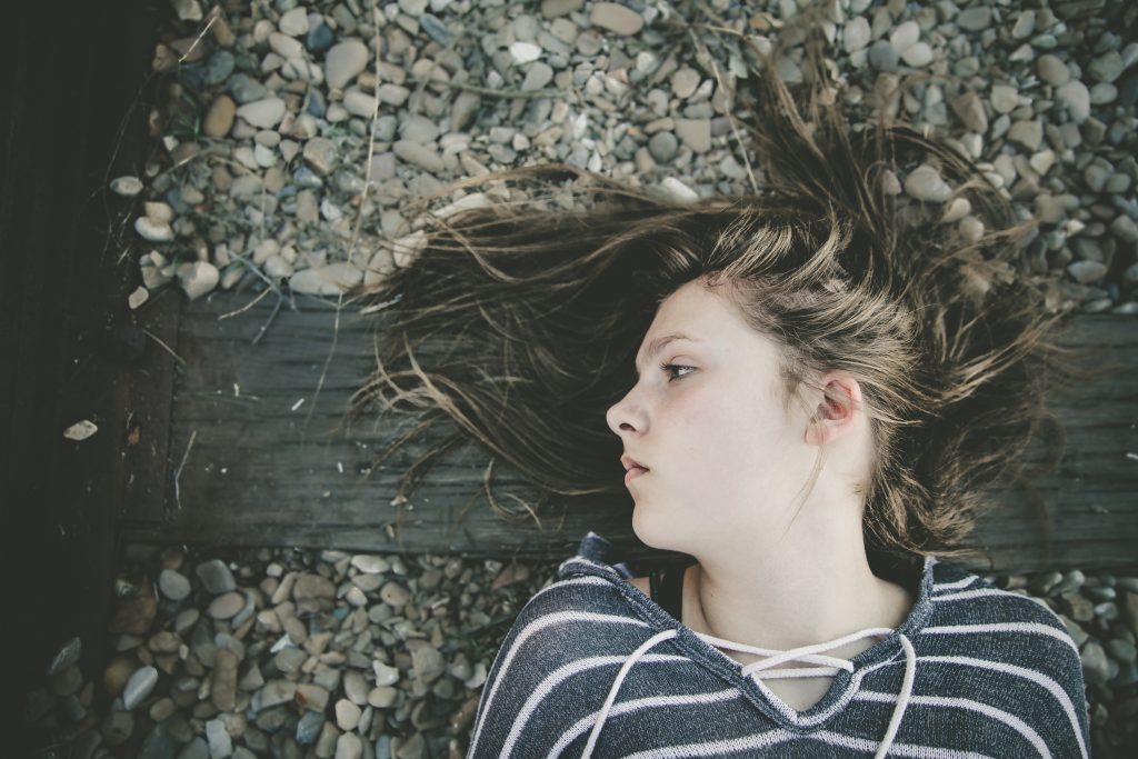 Young woman lying on railroad track. (Getty Images)