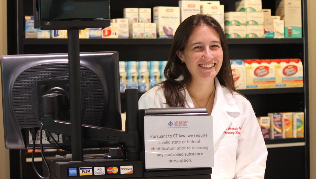 Jill St. Germain '07 (PharmD) greets clients. (Sheila Foran/UConn Photo)