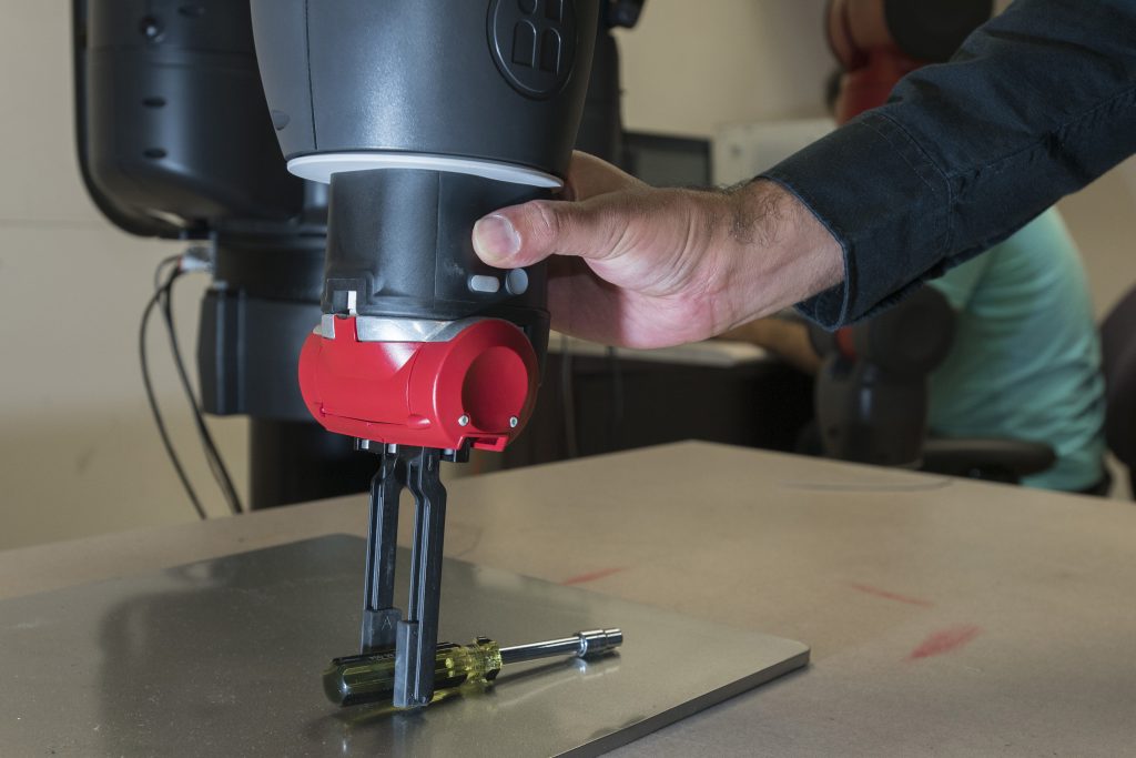 Ashwin Dani, assistant professor of electrical and computer engineering, demonstrates how the robot can be given a simple task which can be repeated. Sept. 7, 2017. (Sean Flynn/UConn Photo)