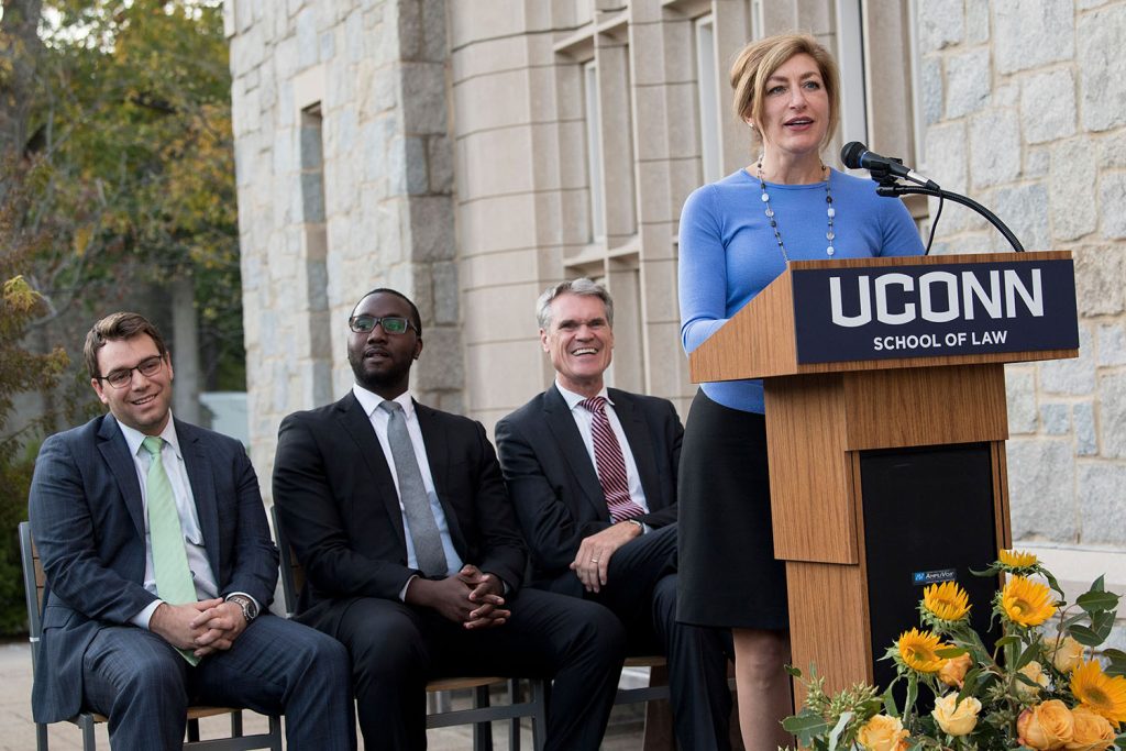 The study of law is a conversation, and the Brown Family Campus Center at UConn School of Law is an ideal place for that conversation to happen, Dean Timothy Fisher said at the dedication of the new café and gathering place on Oct. 18, 2017. Student Gideon Asemnor ‘18 saw a multitude of conversations begin when the campus center opened at the start of the semester. It felt very different from his first year at the law school, when there was only a small cafeteria in the basement of Hosmer Hall and students seemed to disappear right after classes ended, he told the audience at the ceremony. “Starting this semester, there’s been a tremendous change on campus,” he said. “You see students from all walks of life, from different backgrounds, LLMs, JDs, you see them sitting together at the tables, having lunch and discussing tort issues or whatever cold call they got that day,” University President Susan Herbst opened the dedication ceremony with a thank you to the Brown family for generously funding the creation of the campus center in the slate foyer of the Thomas J. Meskill Law Library, facing the main quad. Joe Brown ’16 spoke on behalf of the family, welcoming the center as a place where students have already begun learning and sharing. Before the ceremony, Joe’s father, Jay Brown, discussed the 2008 financial meltdown at a presentation in the Reading Room in William F. Starr Hall with UConn Law Professor James Kwak, author of Thirteen Bankers and Economism. Brown, the retired CEO of MBIA, remembered the most harrowing turns of the crisis and the measures that brought it under control. The dedication ceremony followed, with a reception afterward in the new campus center featuring food catered by the university’s Dining Services team, which operates the café. The café opened Aug. 28 to a steady flow of students, faculty and staff gathering for coffee, meals, conversations and study sessions. In September it served triple the number of customers served in the Hosmer cafeteria in September 2016, according to Retail Operations Manager Ethan Haggerty. The café is open from 8 a.m. to 6:30 p.m. Monday through Thursday and 8 a.m. to 3:30 p.m. on Friday, providing meals for Day and Evening Division students alike. The menu includes soups, salads, sandwiches, pizza, snacks and baked goods. Customers have been enthusiastic about the café and the rest of the campus center. First-year students Kileigh Nassau and Jesse Sahani sit there every day and refer to it as their “office.” Every friendship they’ve made has started there, they said. Tyler Conklin ’18 said the center brings faculty and students together. “I have seen the dean here, and it really breaches the gap,” he said. “It fosters a sense of community on campus that did not exist before.”