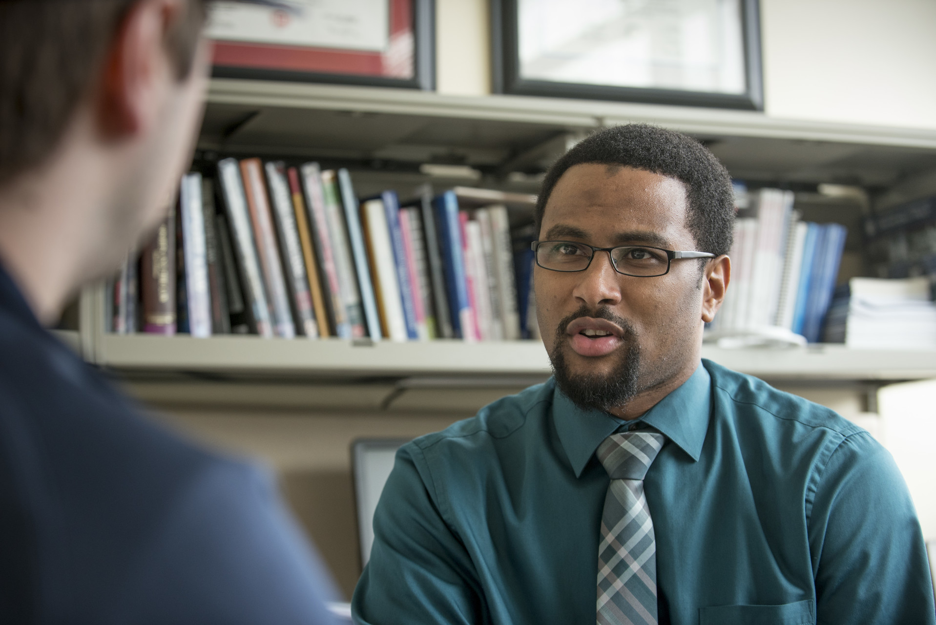 Joseph Cooper, assistant professor, meets with student