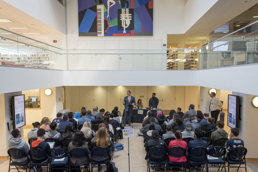 Mark Overmyer-Velázquez, director of UConn Hartford, welcomes attendees at a Metanoia session on 'Islamophobia: A Form of Racism' at the Hartford Public Library. (Sean Flynn/UConn Photo)