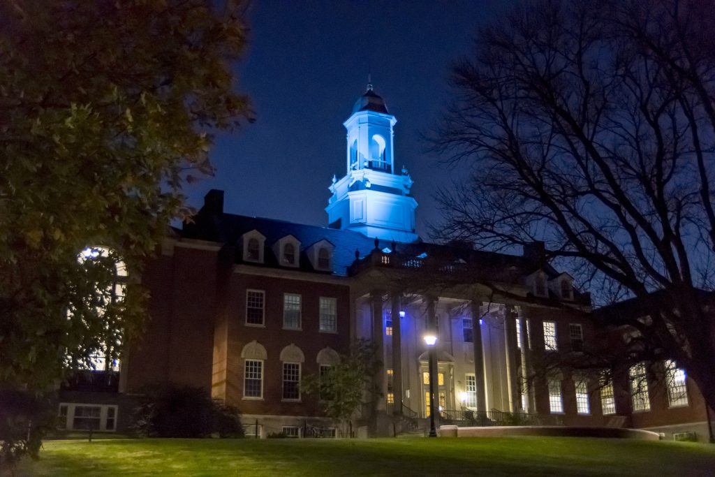 An exterior view of Wilbur Cross lit up teal to promote awareness of Alzheimer's disease. (Garrett Spahn/UConn Photo)