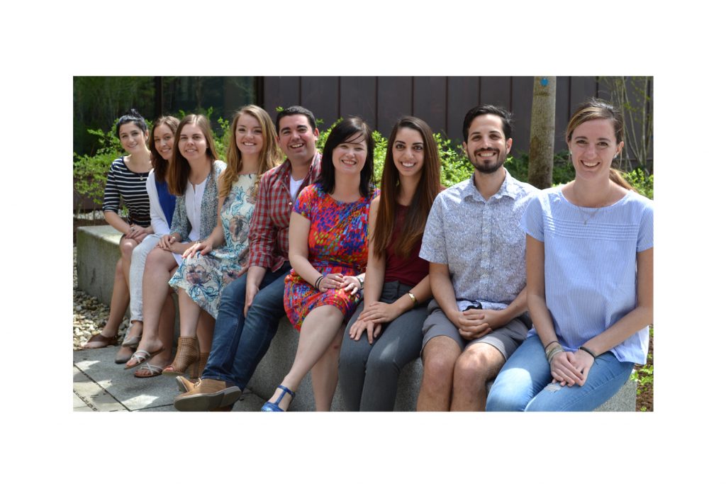 Erika Skoe and eight students in her lab sit outside of Oak Hall.