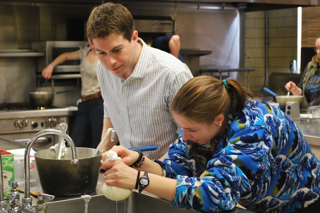 Students in D’Amico’s class make fresh mozzarella as he looks on.