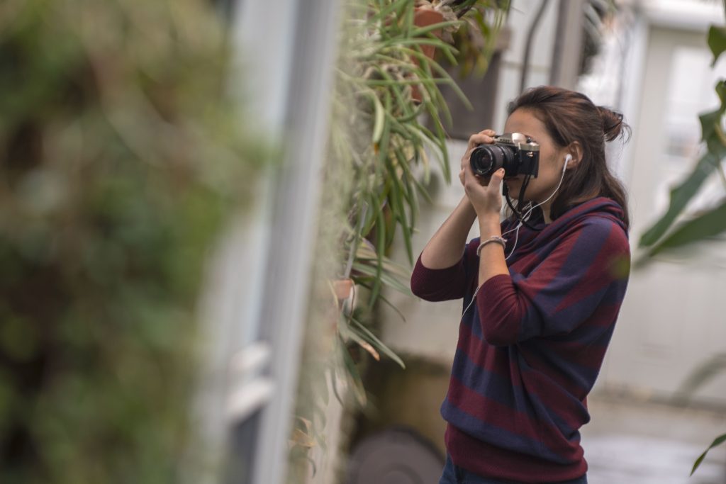 Marissa Aldieri '18 (CLAS), an individualized major, takes photos for Intermediate Photography taught by Kaleigh Rusgrove at the UConn Biodiversity Education and Research Greenhouses on Feb. 12, 2018. (Garrett Spahn '18 (CLAS)/UConn Photo)