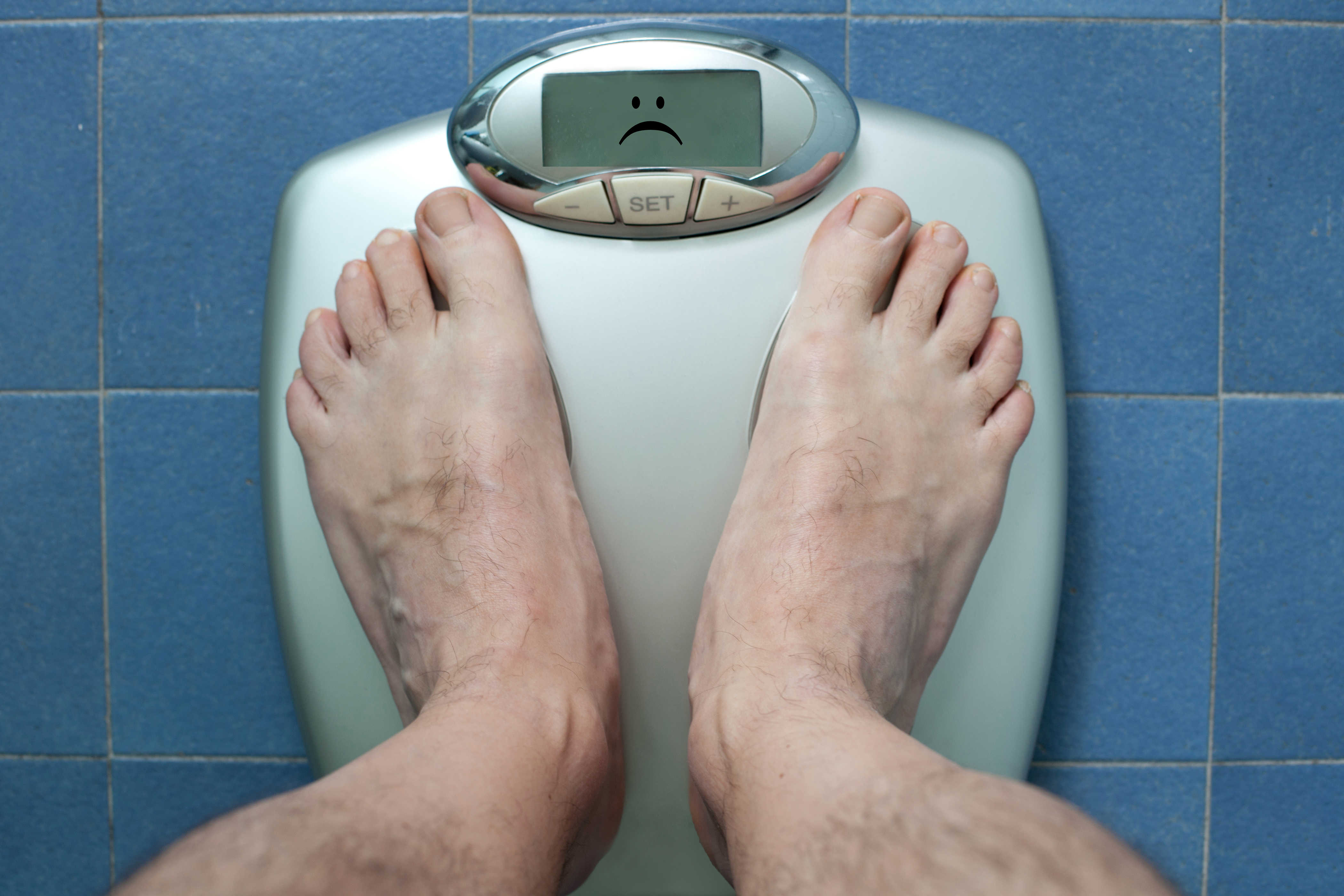 A man weighing himself. (Nico De Pasquale Photography/Getty Images)