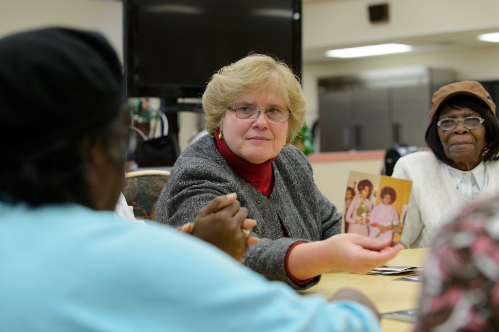 Juliette Shellman, associate professor of nursing, speaks with seniors at the North End Senior Center in Hartford. (Peter Morenus/UConn File Photo)