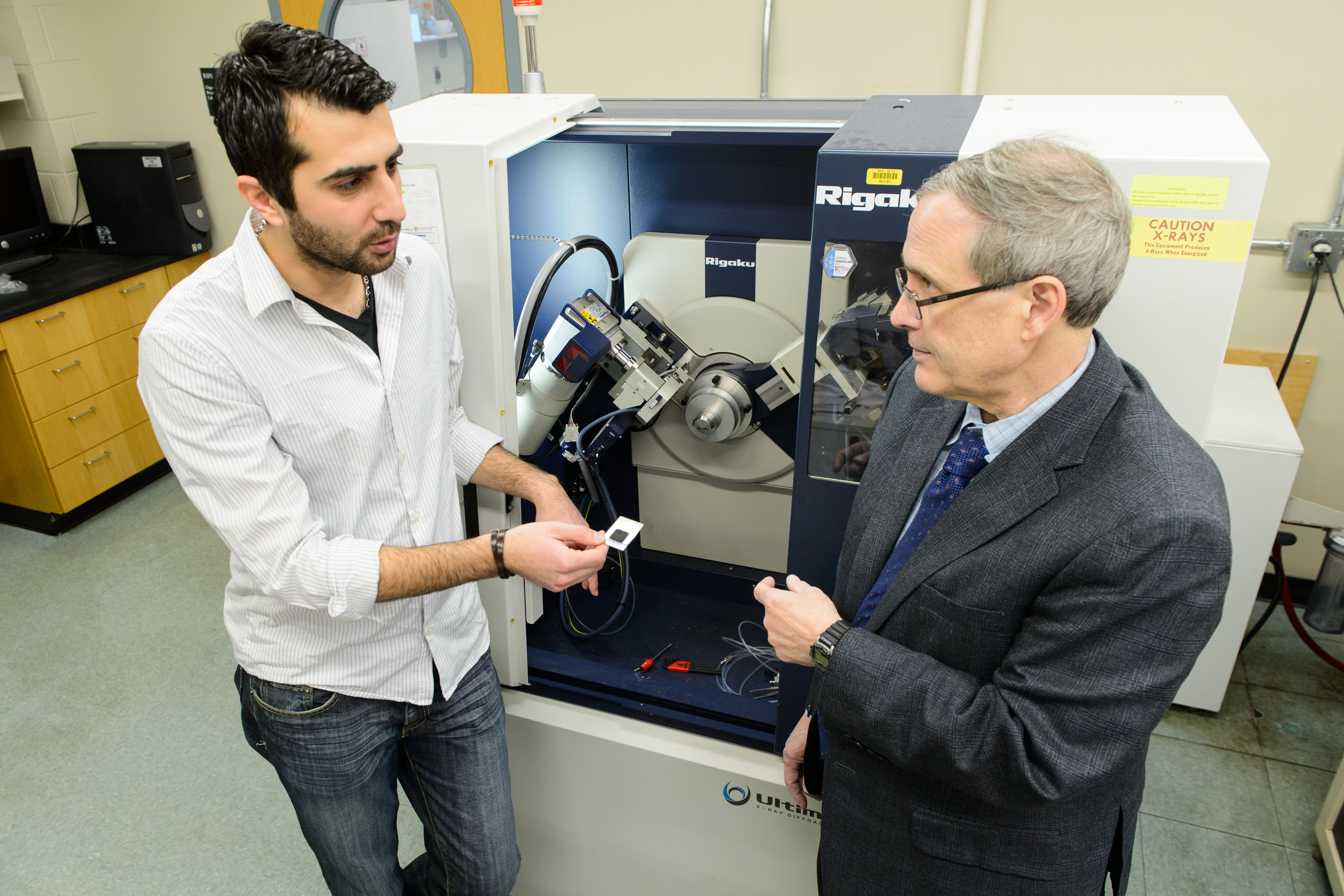 Altug Poyraz, left, with Steven Suib, distinguished professor of chemistry. (Peter Morenus/UConn Photo)