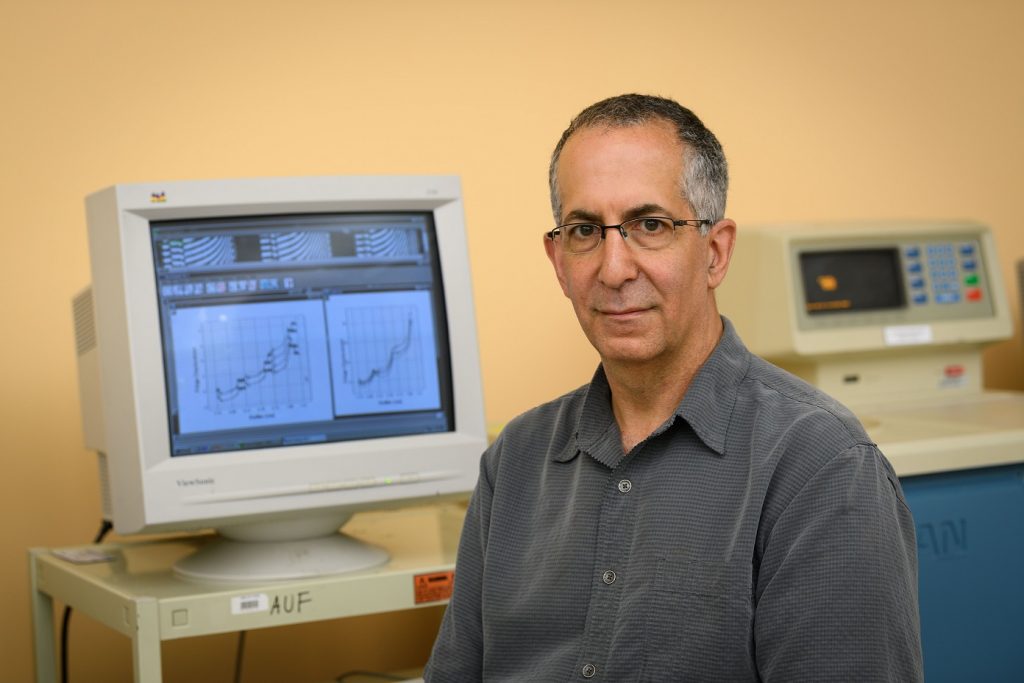 James Cole, professor of molecular and cell biology, with a ultracentrifuge at the Biology/Physics Building on July 27, 2017. (Peter Morenus/UConn Photo)