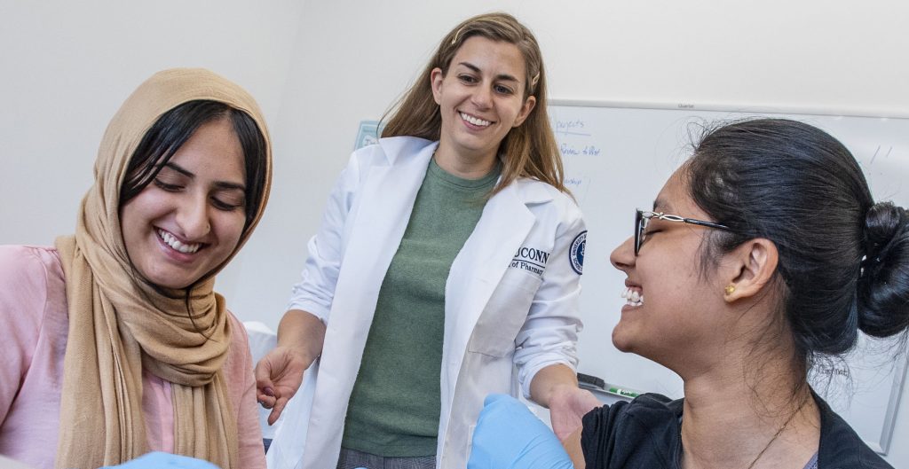 Assistant Professor Stephanie Gernant instructing (left) Muryam Khan ‘22 and Sidra Khan ’22, instruct P1 students during immunization training at the School of Pharmacy