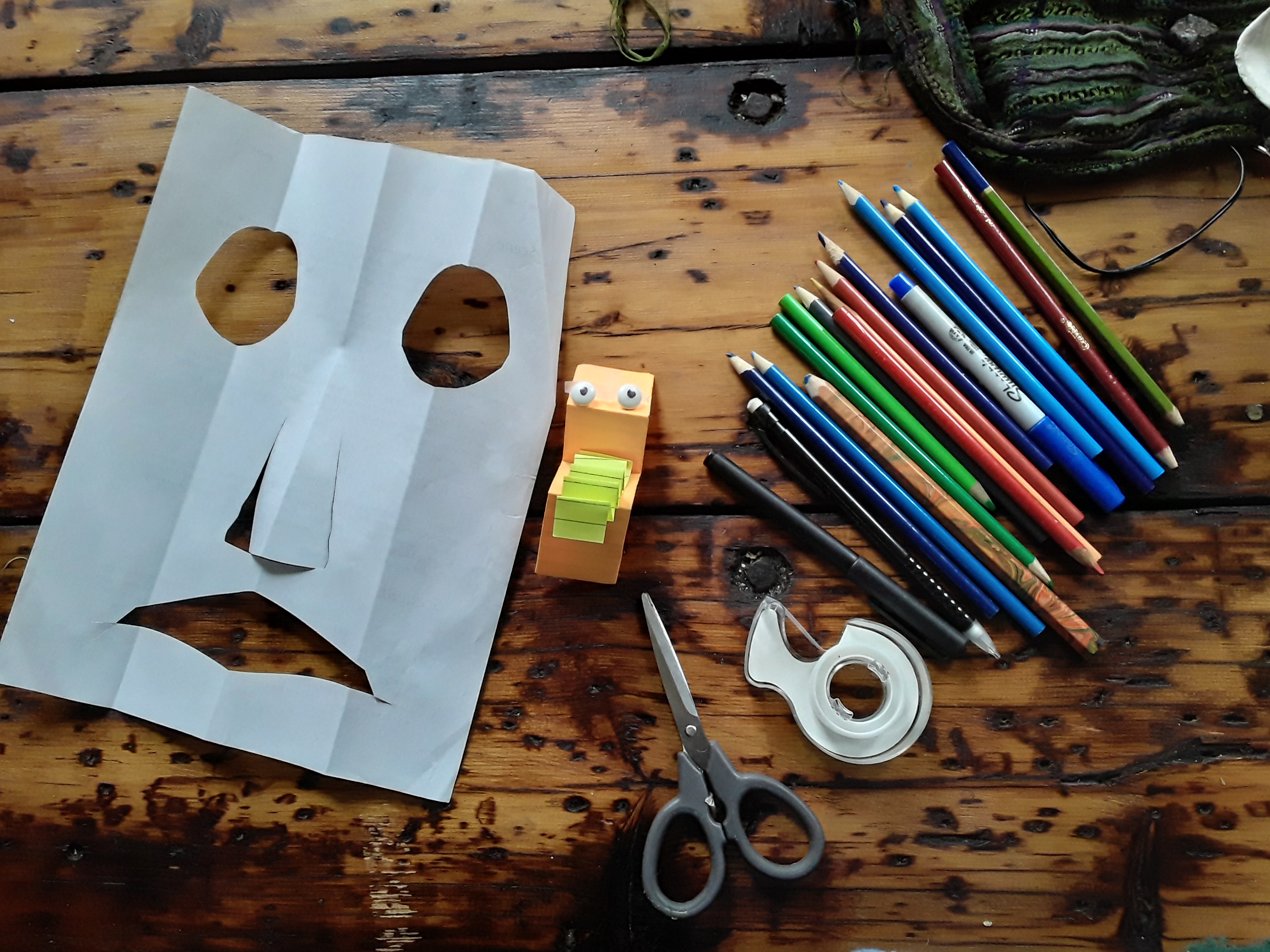 Materials arrayed on a table for the Ballard Institute paper puppet workshop.