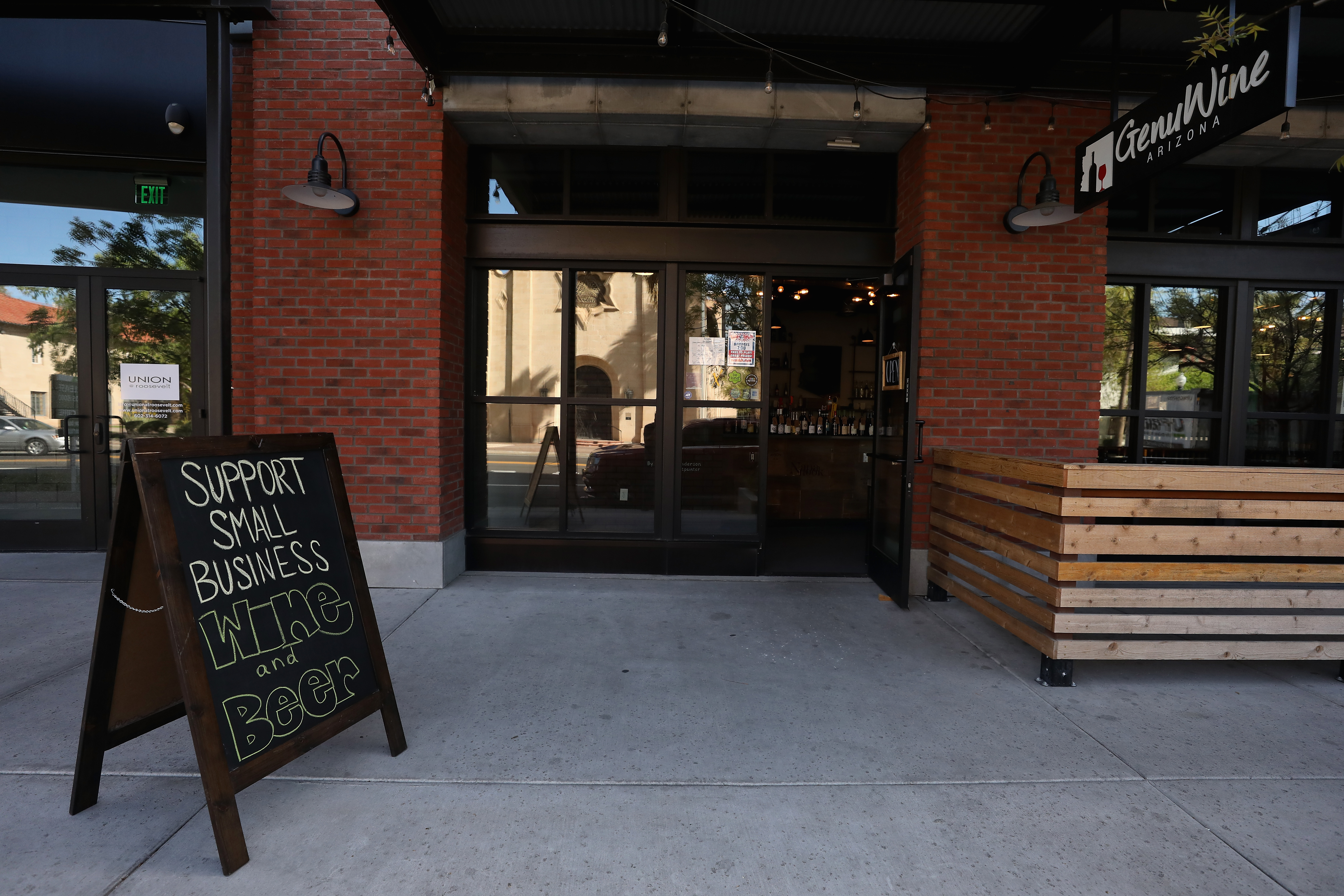 A store with a sign in front that says "Support Local Business."