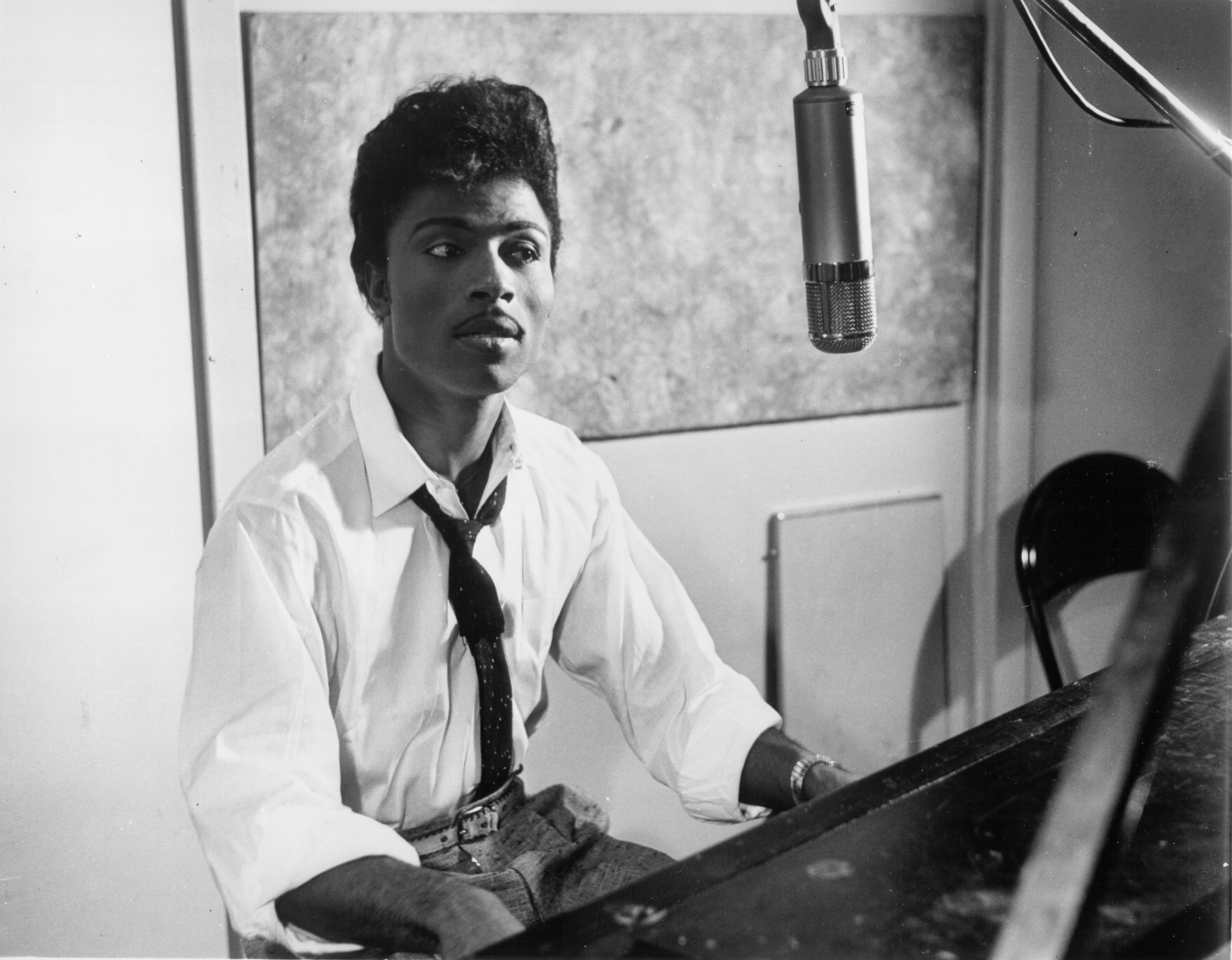 Musician Little Richard performs on the recording studio at a microphone and piano in circa 1959.