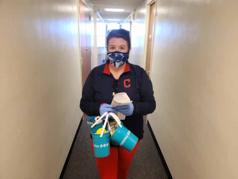 a woman passing out goodie bags