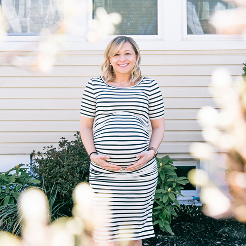 Pregnant woman holding her stomach.