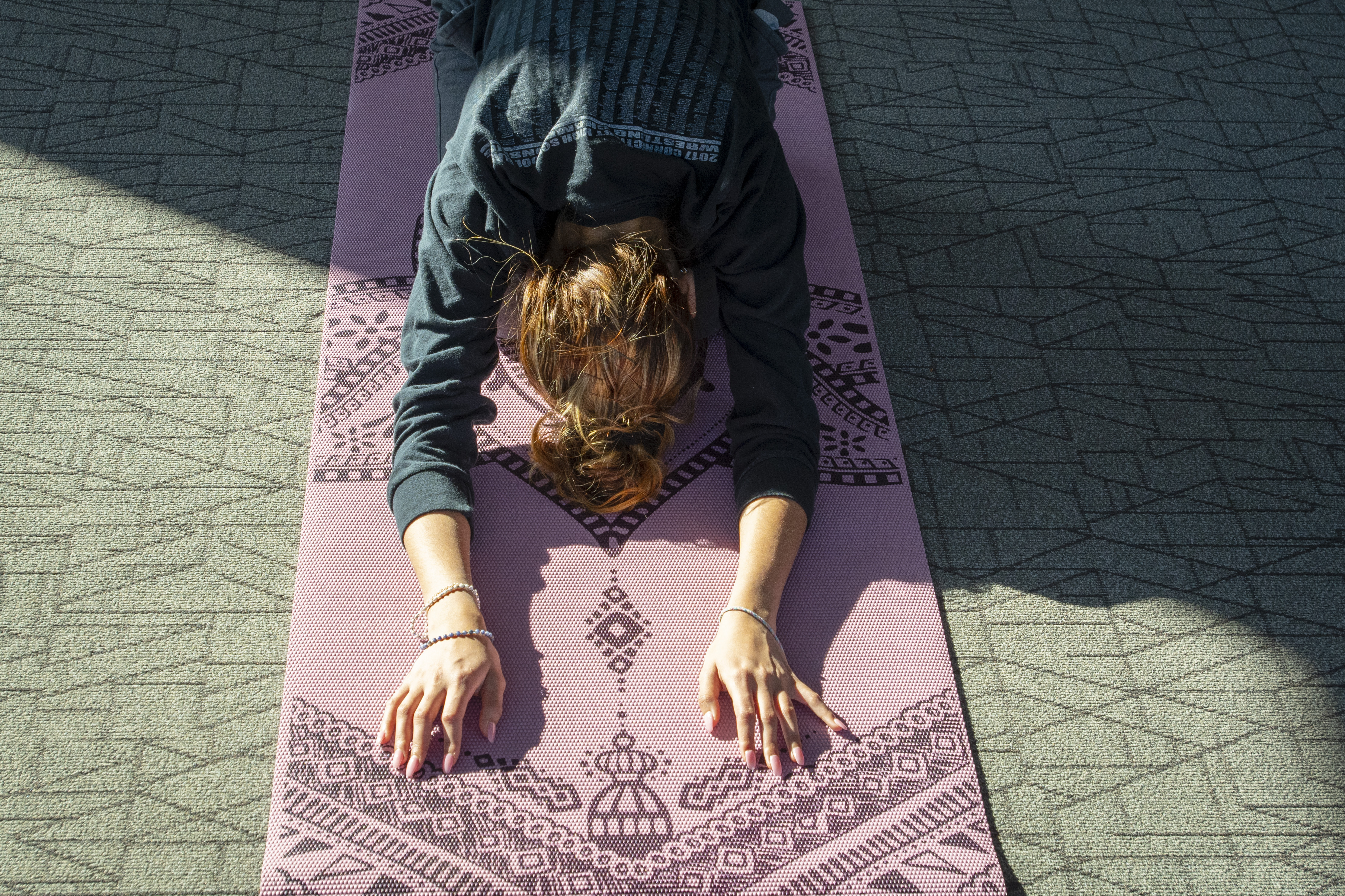 Woman rests in child's pose during a yoga and mindfulness class.