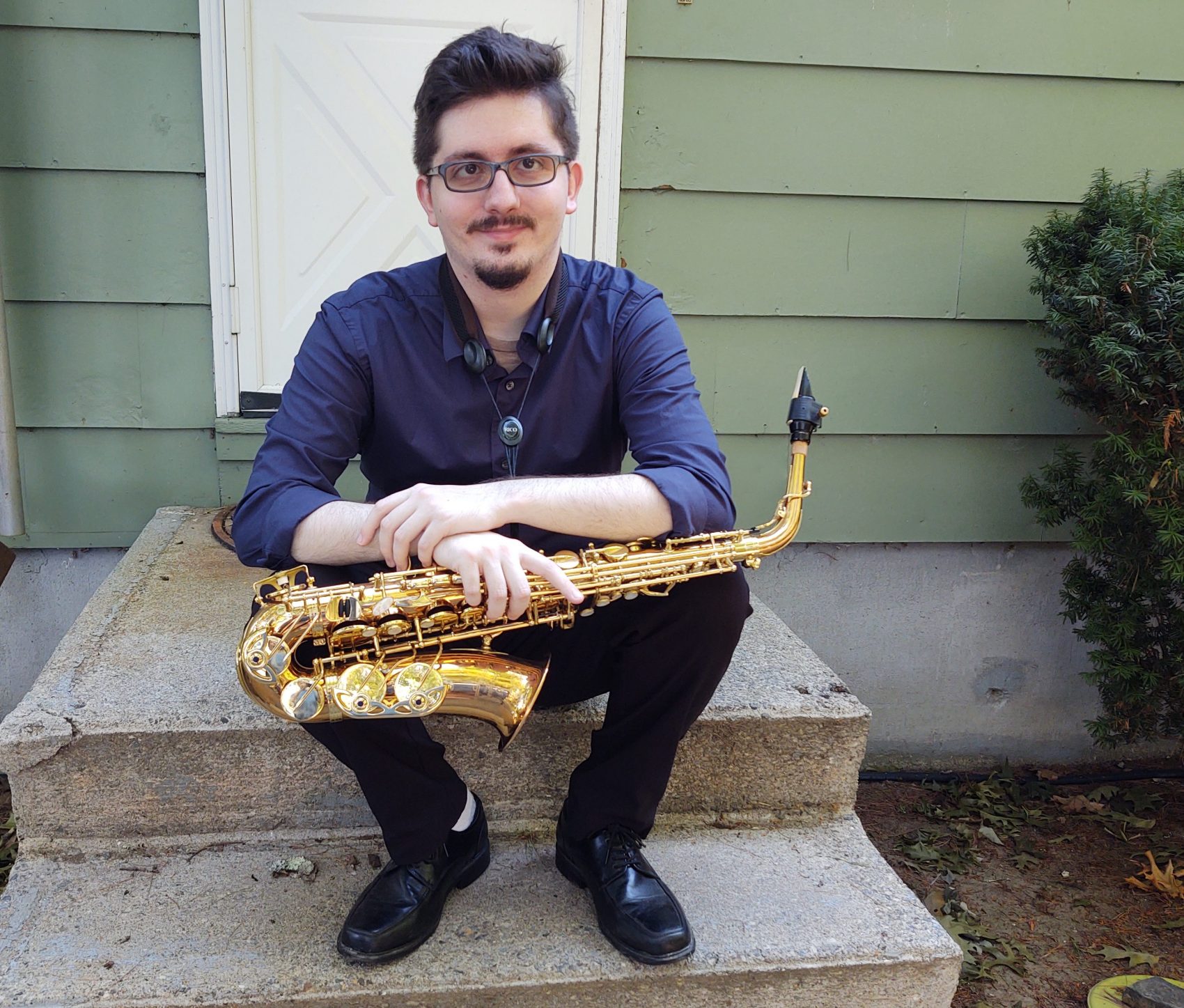 a man holding a saxaphone